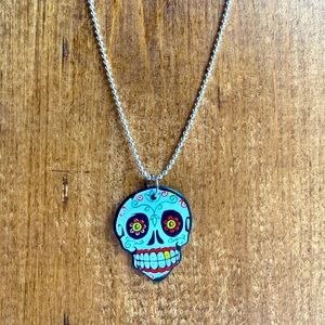 Sugar skull guitar pick necklace.